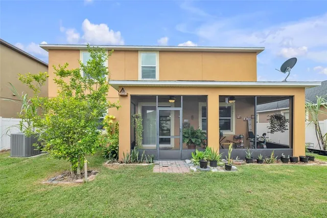 a view of a house with a yard and plants