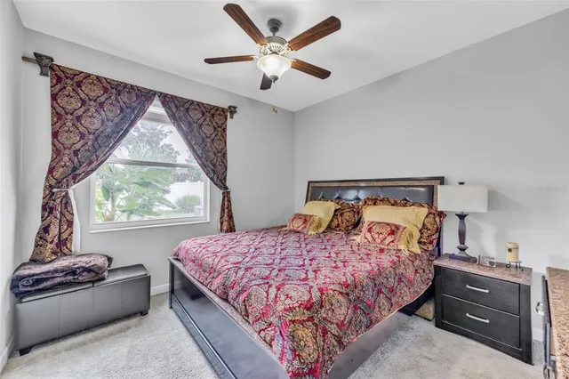 a bedroom with a bed and a large window