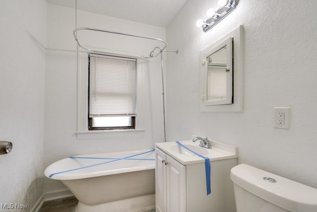 1618 Catalpa Road Cleveland, OH 44112 - Photo 19 of 33 Bathroom featuring a textured wall, vanity, and a combined bath / shower with freestanding tub