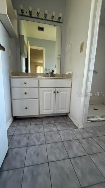 233 West Citrus Street Altamonte Springs, FL 32714 - Photo 14 of 19 a bathroom with a sink a mirror and a vanity
