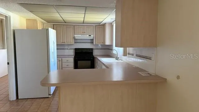 a kitchen with stainless steel appliances a refrigerator and a counter