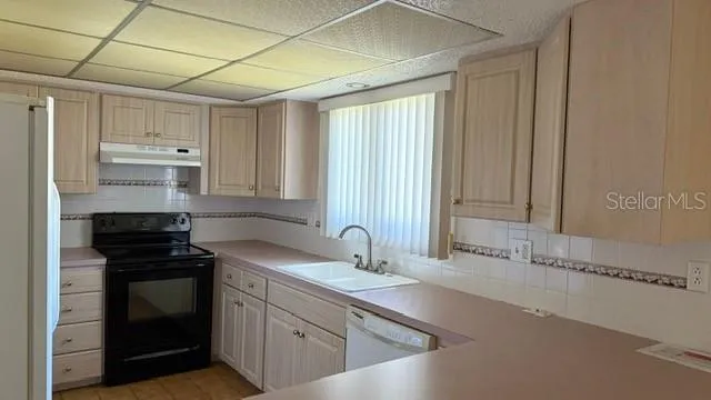 a kitchen with a sink stove and cabinets