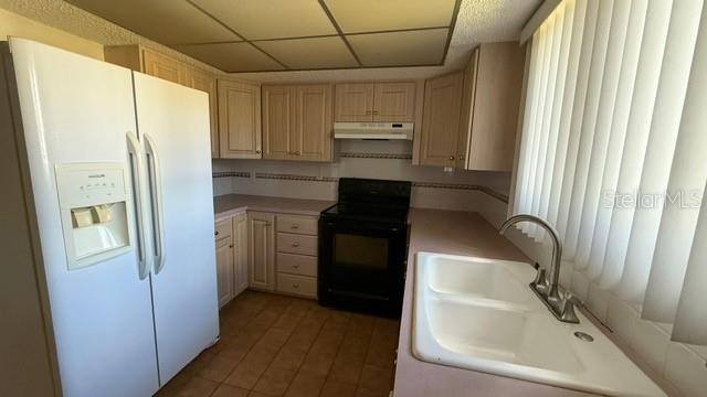 233 West Citrus Street Altamonte Springs, FL 32714 - Photo 4 of 19 a kitchen with a refrigerator and a sink