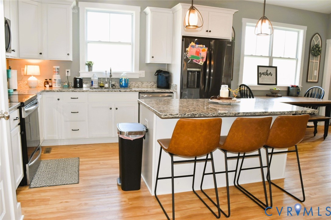 288 Moore Road Farmville, VA 23901 - Photo 16 of 33 a kitchen with stainless steel appliances granite countertop a table chairs sink and cabinets