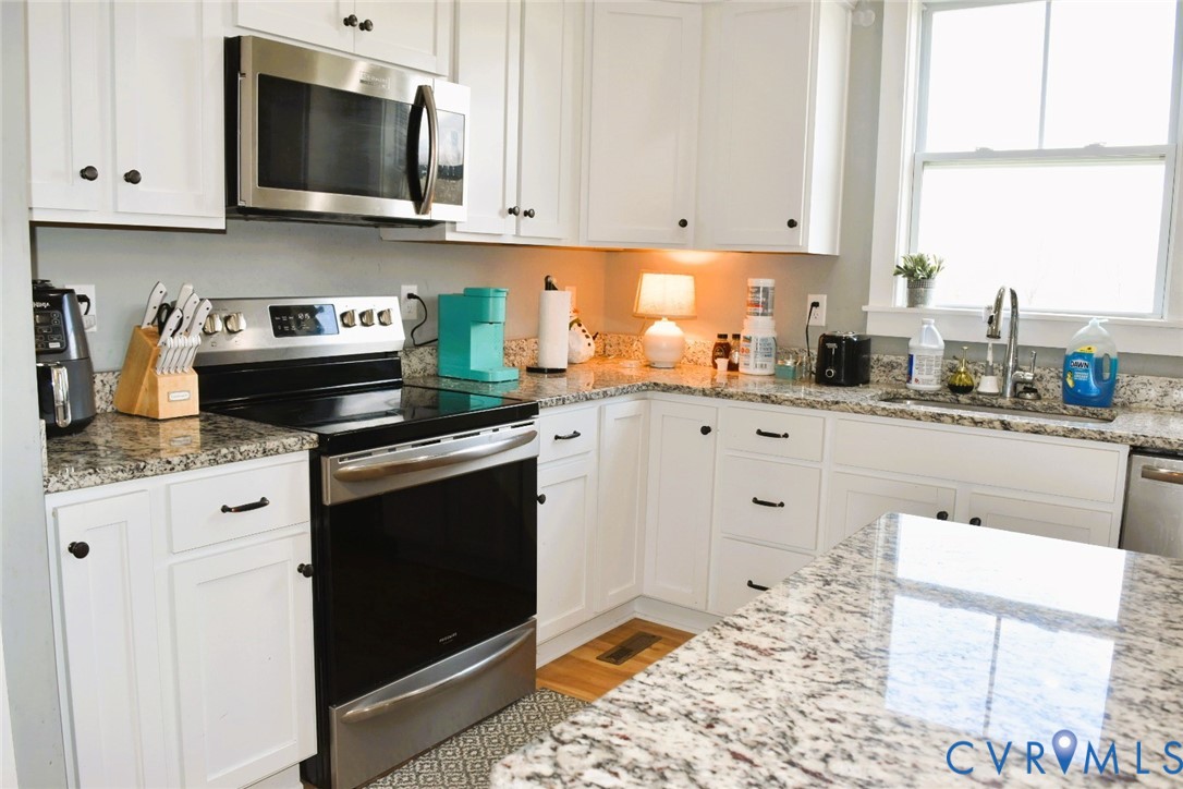 288 Moore Road Farmville, VA 23901 - Photo 18 of 33 a kitchen with stainless steel appliances granite countertop a stove a sink and a microwave
