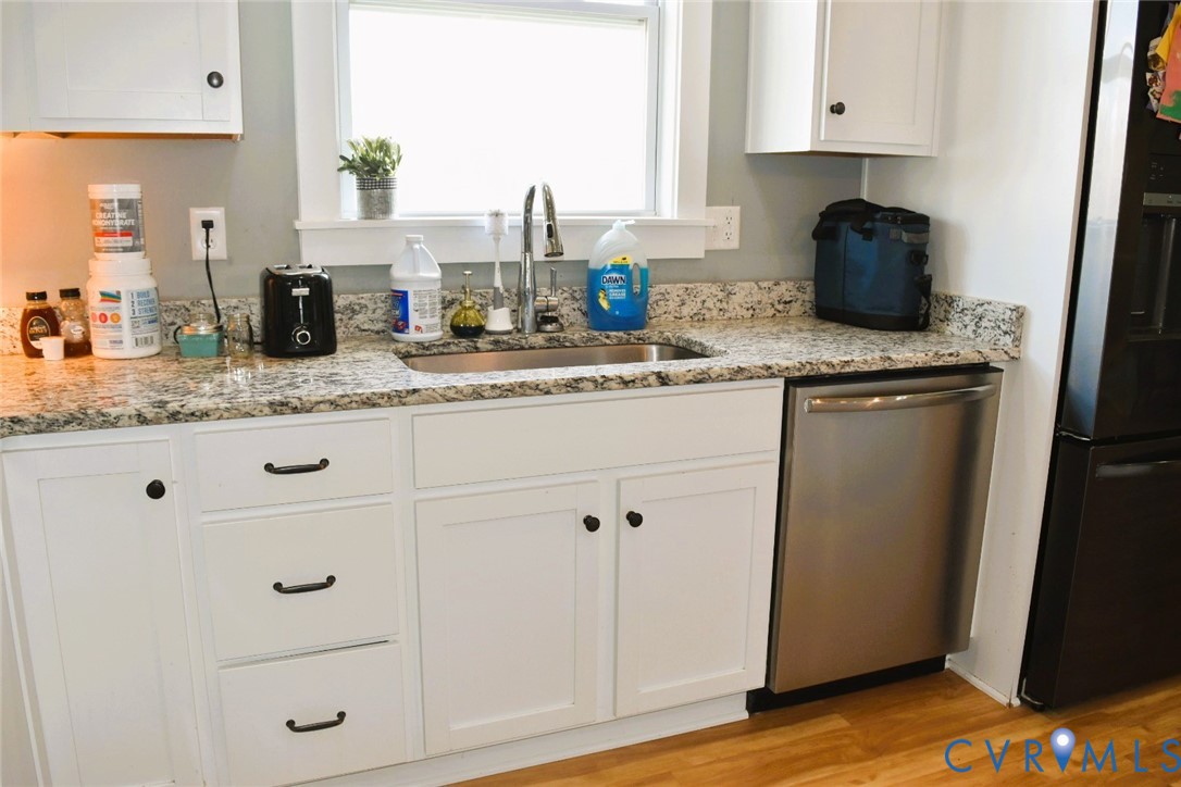 288 Moore Road Farmville, VA 23901 - Photo 19 of 33 a kitchen with granite countertop white cabinets and white appliances