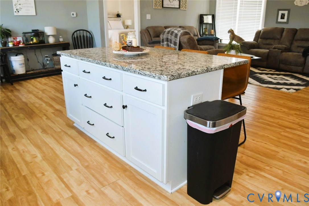 288 Moore Road Farmville, VA 23901 - Photo 20 of 33 a kitchen with granite countertop a sink and a stove with wooden floor