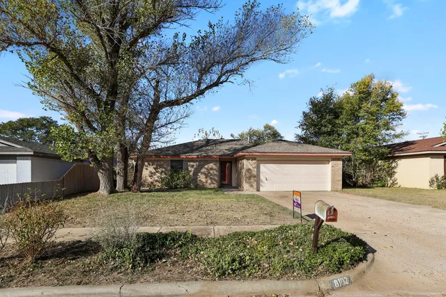 a front view of a house with a yard covered with snow