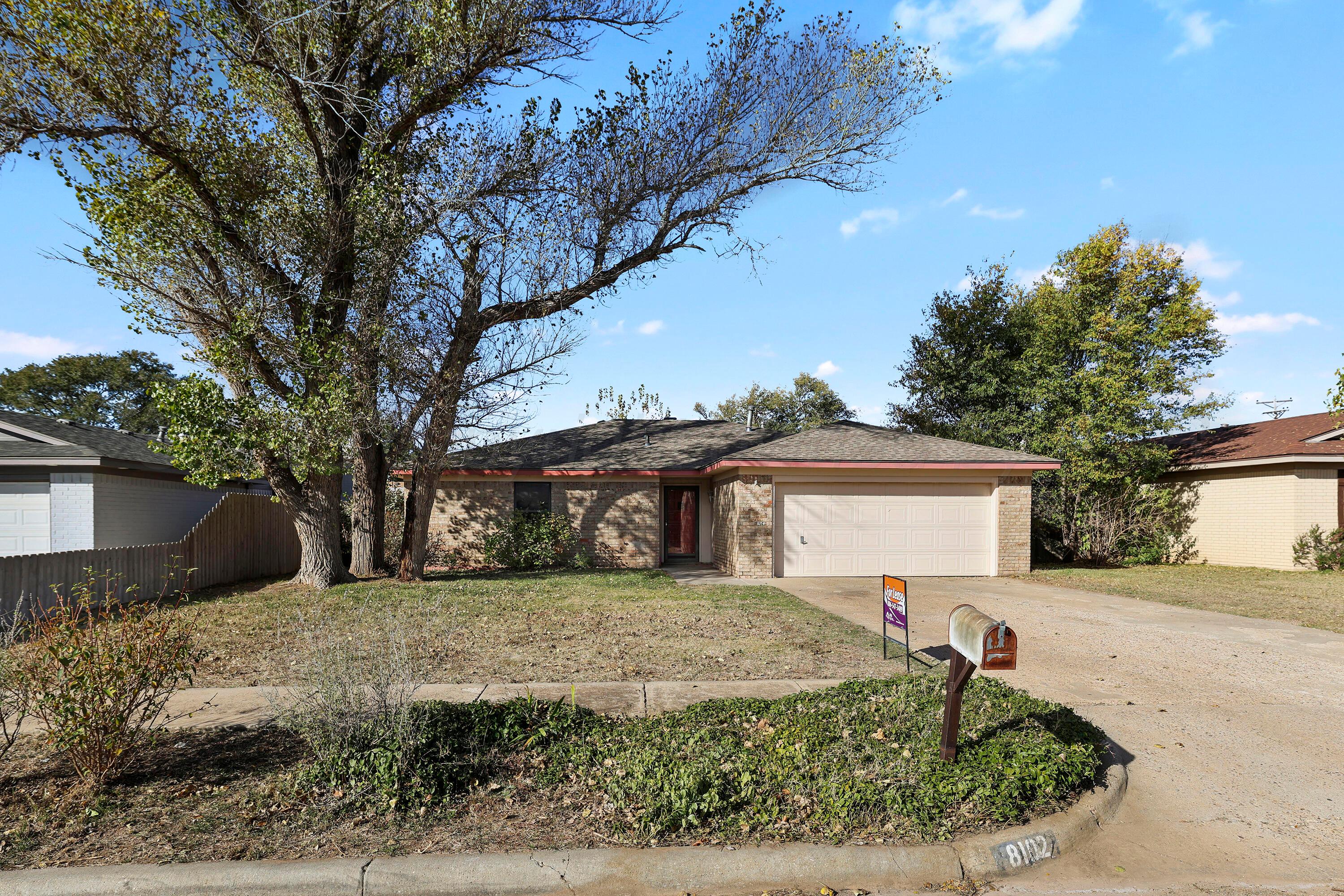 a front view of a house with a yard covered with snow