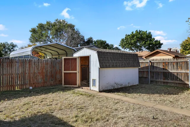 a view of a house with a wooden fence