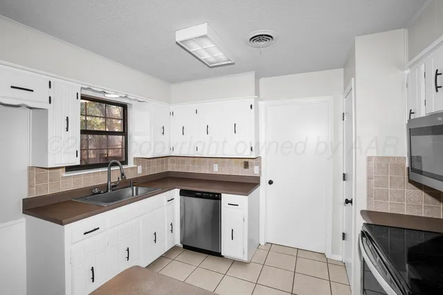 a kitchen with a sink and cabinets