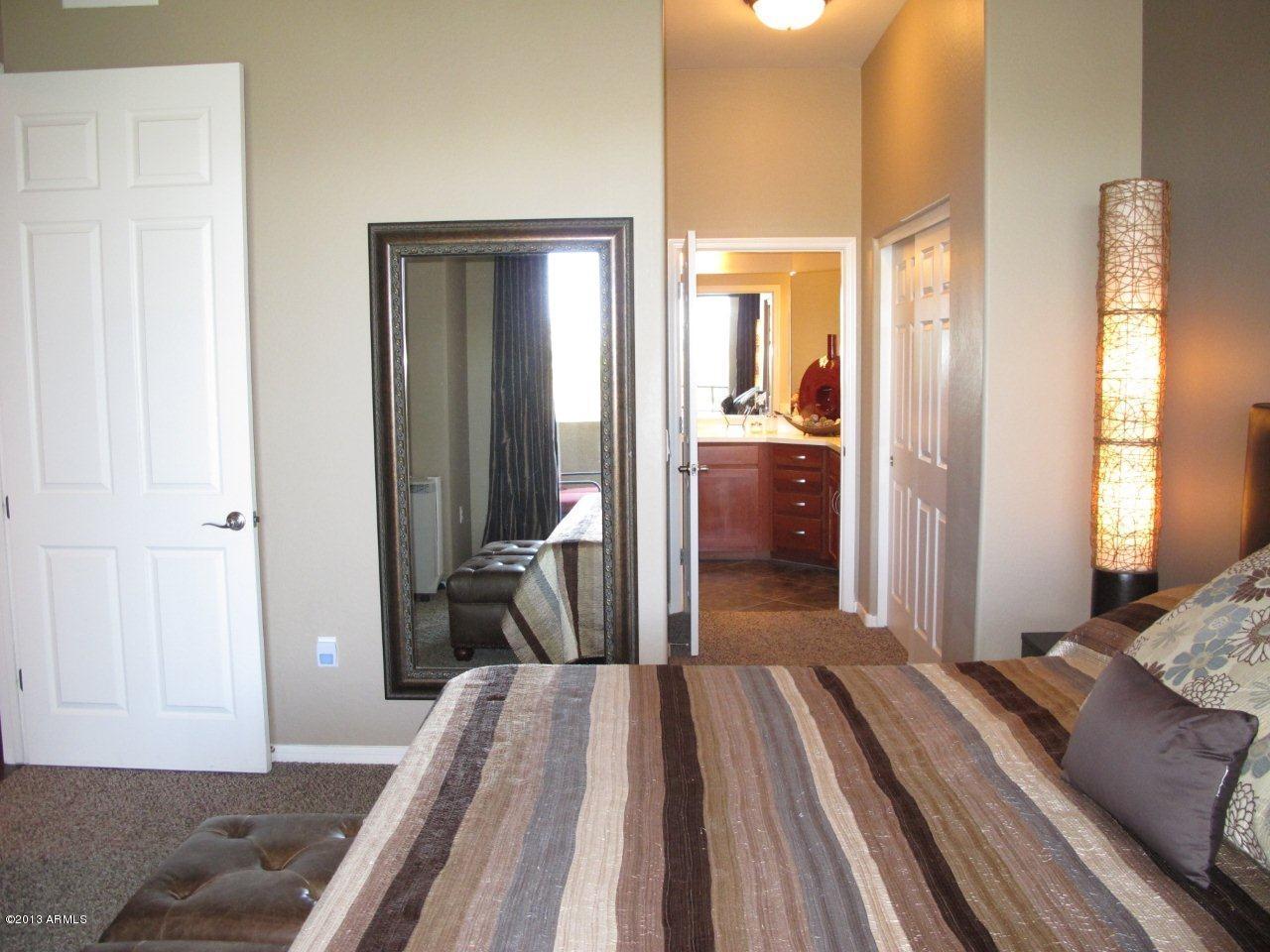 3330 South Gilbert Road, Unit 2014 Chandler, AZ 85286 - Photo 12 of 30 a bedroom with a bed and wooden floor