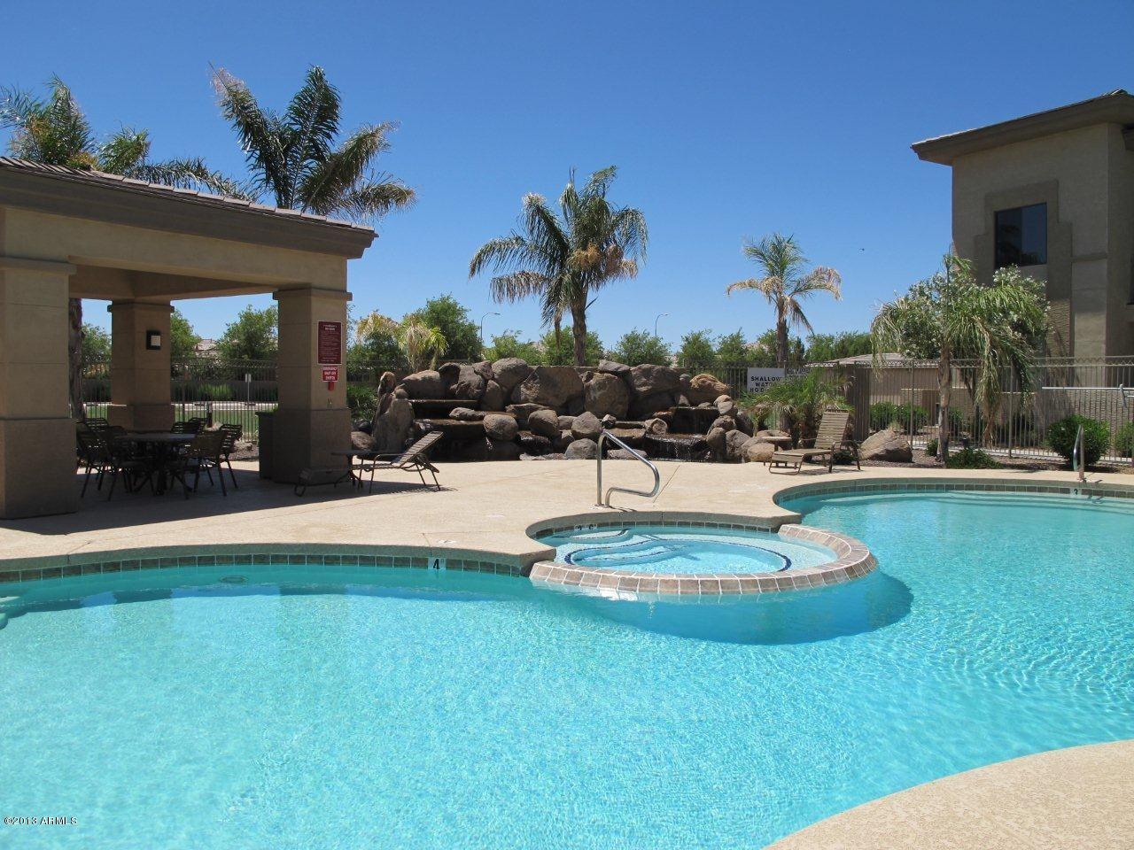 3330 South Gilbert Road, Unit 2014 Chandler, AZ 85286 - Photo 24 of 30 a swimming pool with outdoor seating and yard
