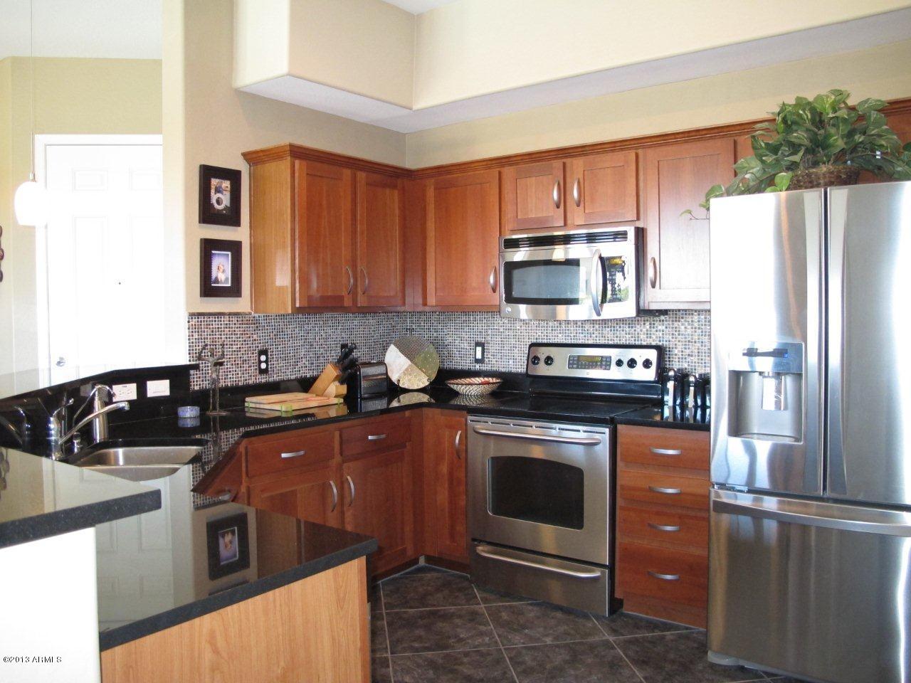3330 South Gilbert Road, Unit 2014 Chandler, AZ 85286 - Photo 7 of 30 a kitchen with a sink stove and refrigerator