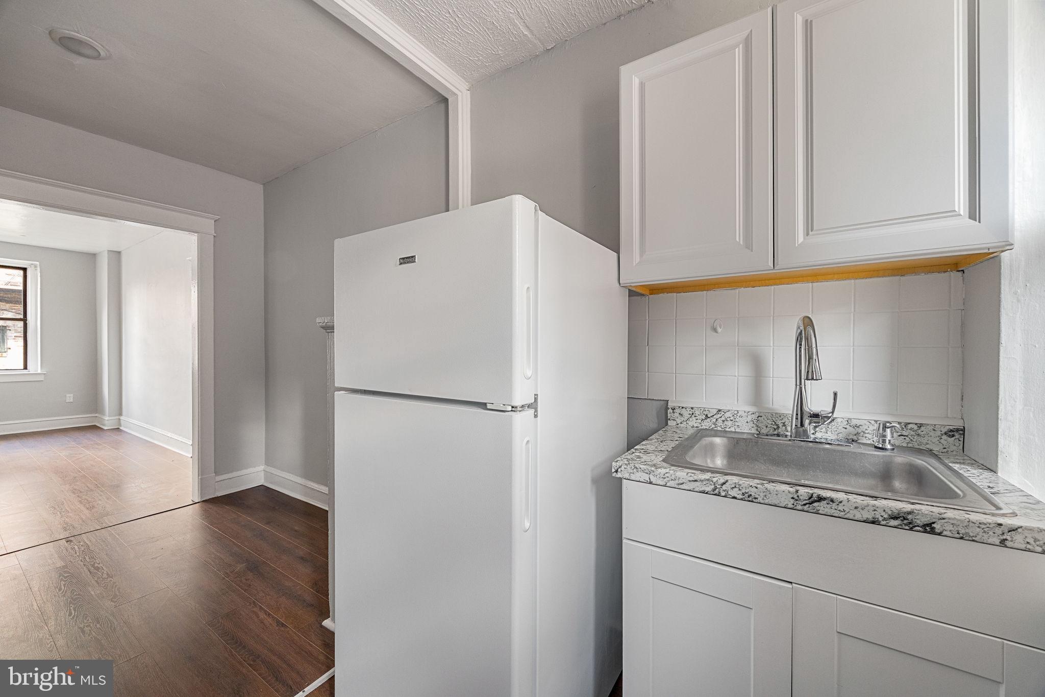 0 Garrett Road, Unit F101 Upper Darby, PA 19082 - Photo 11 of 22 a white refrigerator freezer sitting inside of a kitchen