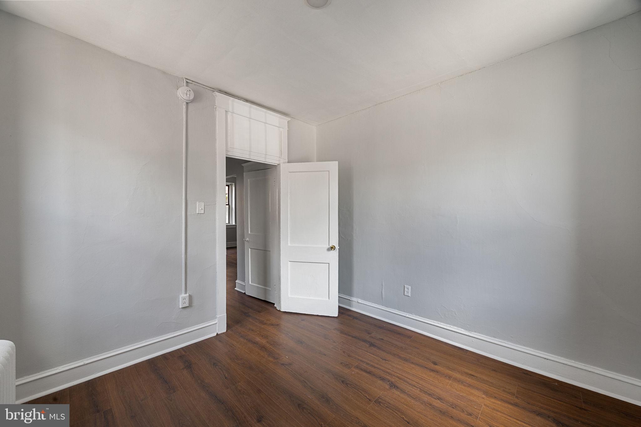 0 Garrett Road, Unit F101 Upper Darby, PA 19082 - Photo 17 of 22 a view of an empty room with wooden floor
