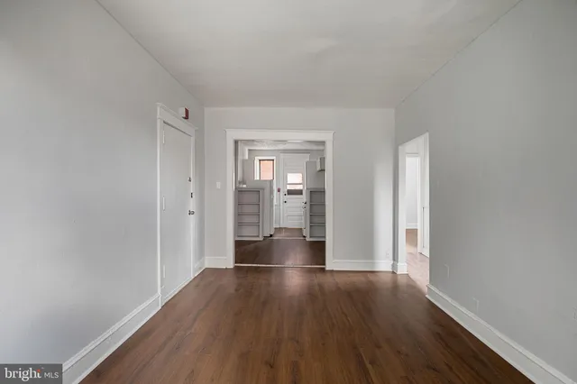 a view of walk in closet with empty racks