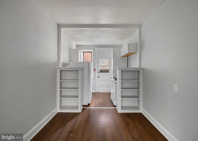 a kitchen with a refrigerator stove and cabinets