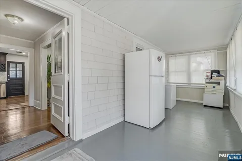 a kitchen with white cabinets and white stainless steel appliances