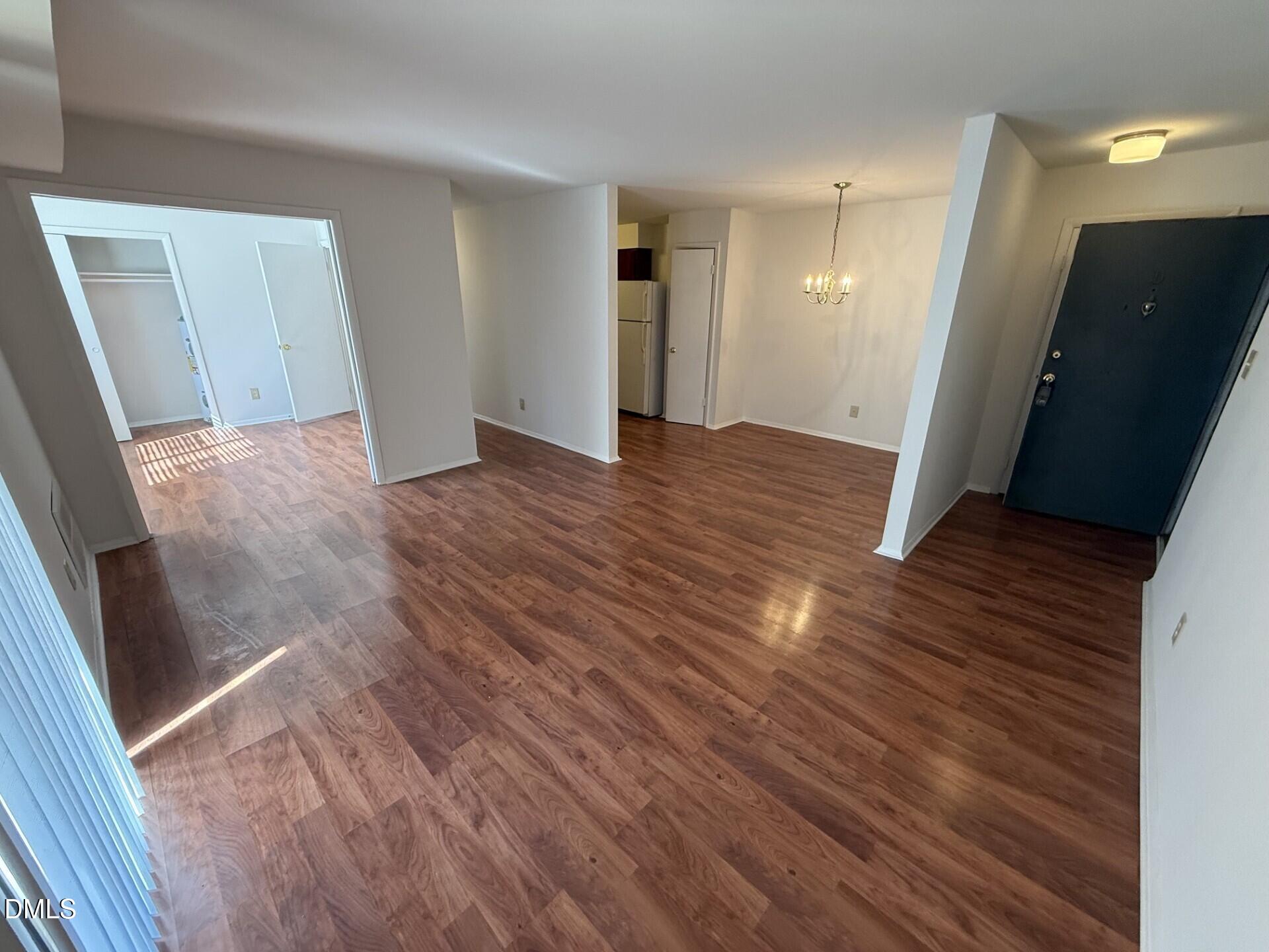 1299 Schaub Drive, Unit D Raleigh, NC 27606 - Photo 2 of 16 wooden floor in an empty room with wooden floor