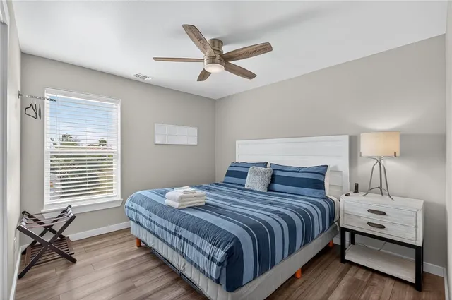 a bedroom with a bed and a table with a chandelier