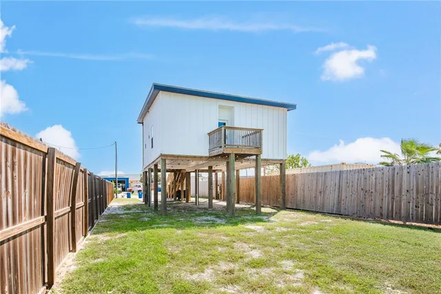 a view of a backyard with wooden fence