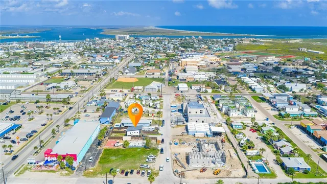 an aerial view of residential houses with outdoor space and swimming pool