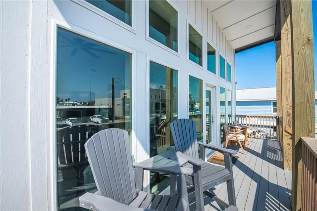 a view of a balcony dining table and chairs