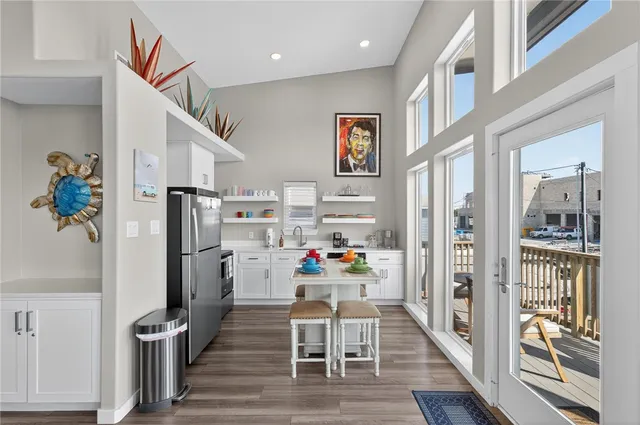 a view of a hallway with wooden floor and dining room