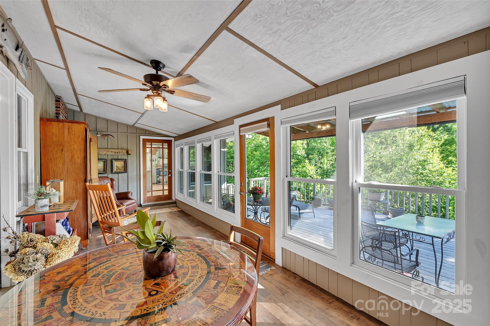 7 Hearthstone Lane Landrum, SC 29356 - Photo 11 of 43 a room with furniture large windows and wooden floor