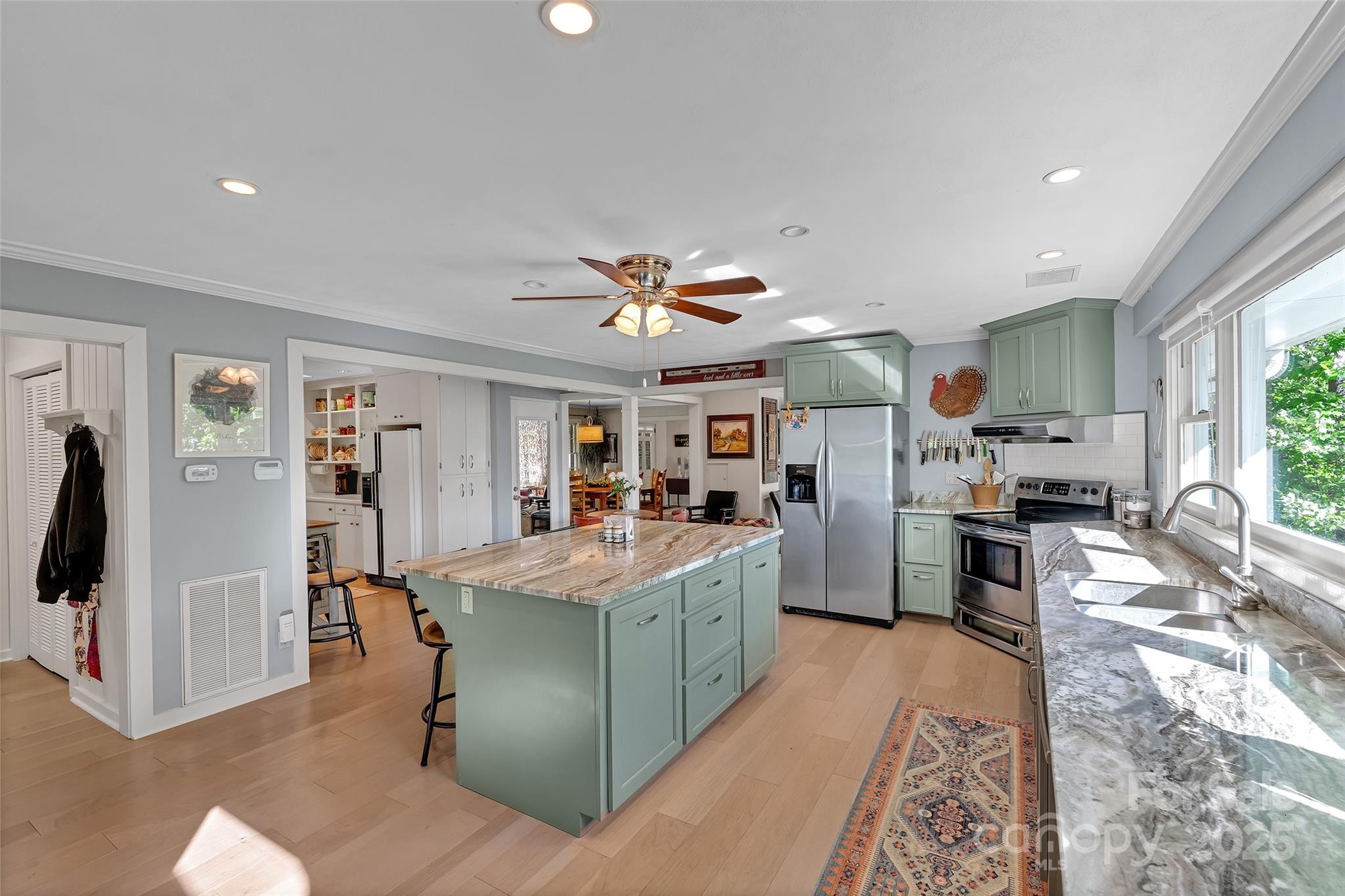 7 Hearthstone Lane Landrum, SC 29356 - Photo 2 of 43 a kitchen with stainless steel appliances kitchen island granite countertop a refrigerator oven a sink dishwasher and white cabinets with wooden floor