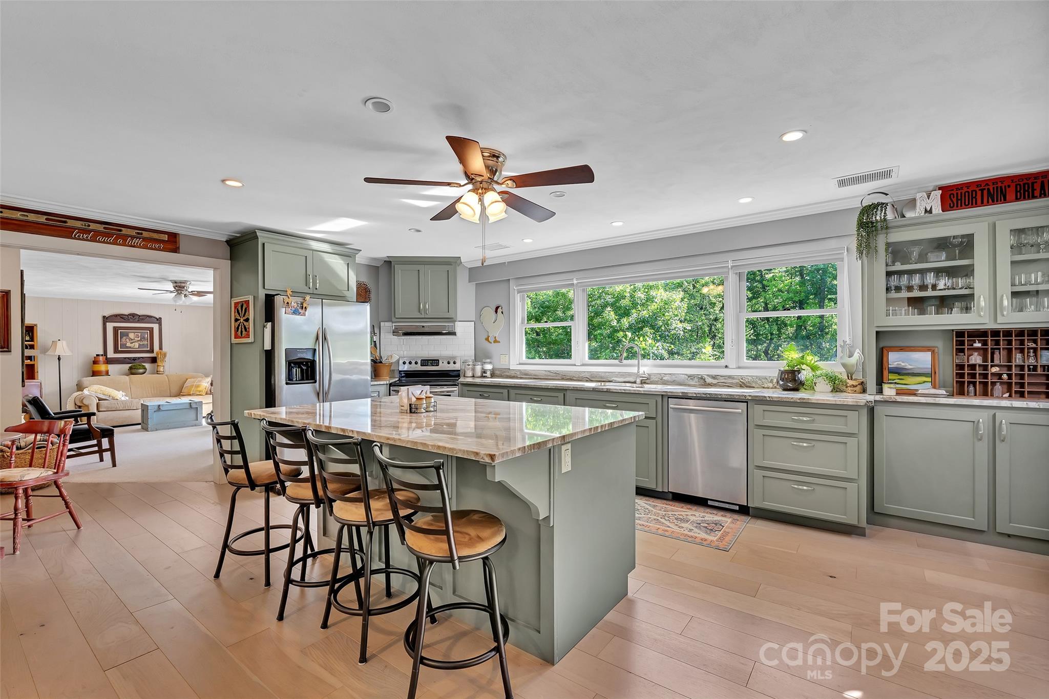 7 Hearthstone Lane Landrum, SC 29356 - Photo 28 of 43 a kitchen with a table chairs refrigerator and cabinets