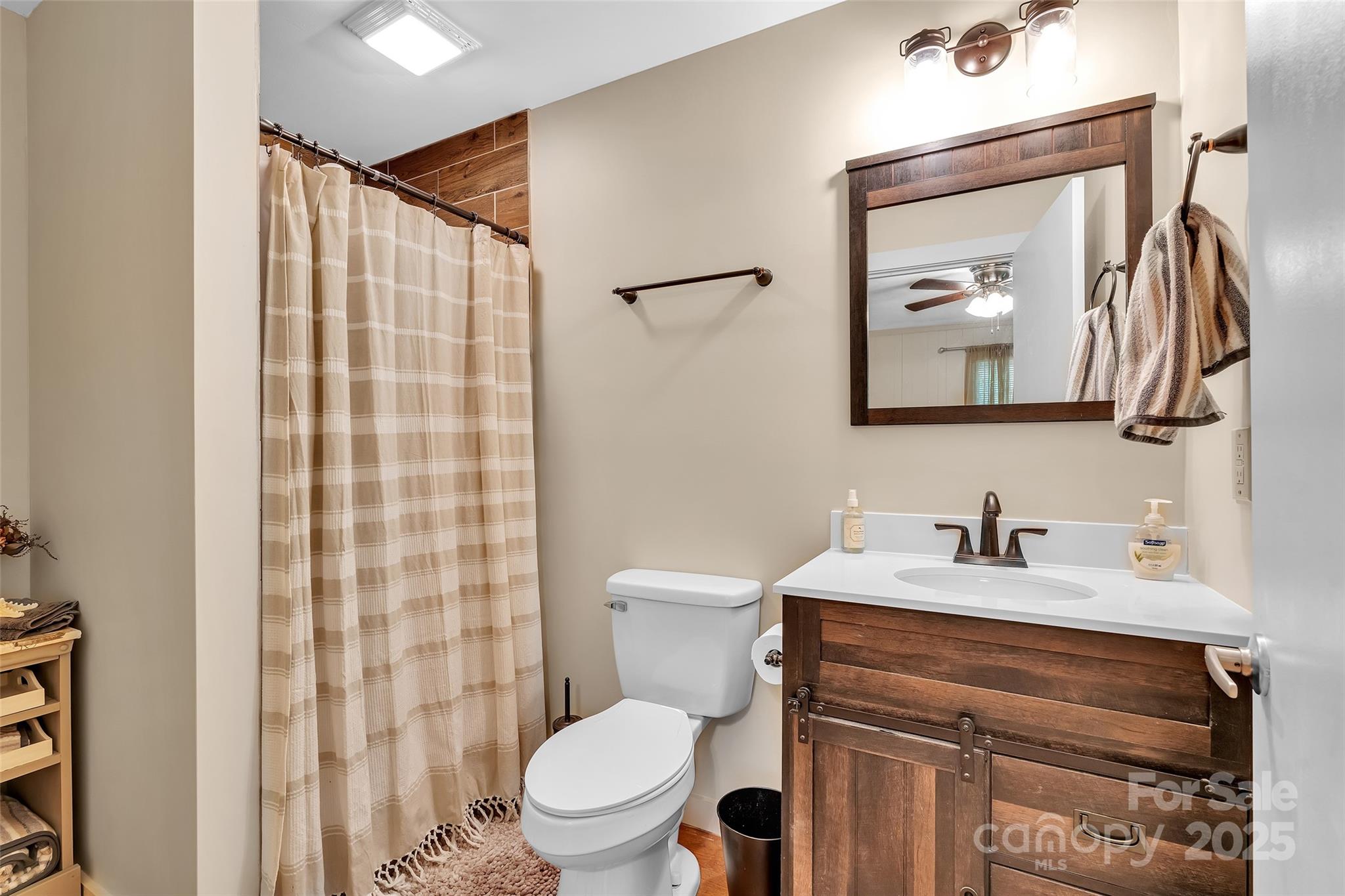 7 Hearthstone Lane Landrum, SC 29356 - Photo 29 of 43 a bathroom with a sink vanity mirror and toilet