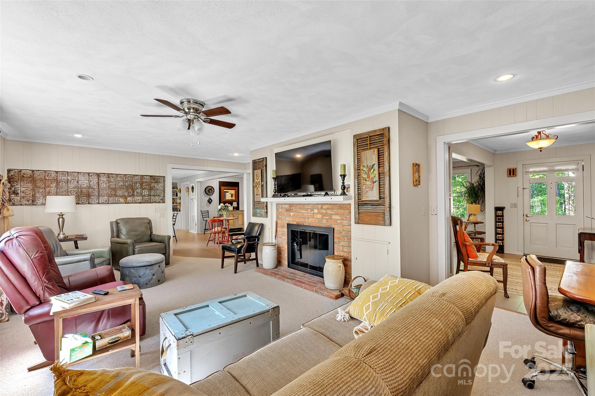 7 Hearthstone Lane Landrum, SC 29356 - Photo 9 of 43 a living room with furniture a fireplace and a flat screen tv