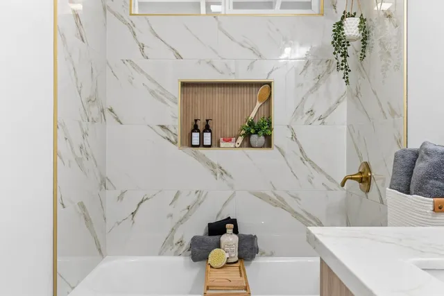 a bathroom with a bathtub and shower