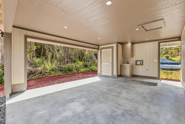 an empty room with a yard and refrigerator