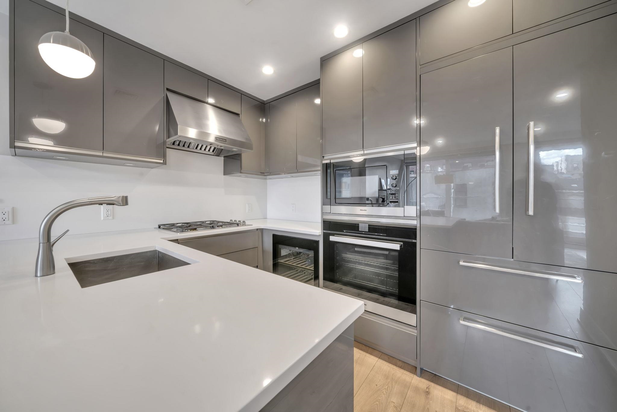 61 14th Street, Unit 3 Hoboken, NJ 07030 - Photo 12 of 31 a kitchen with a sink stainless steel appliances and cabinets