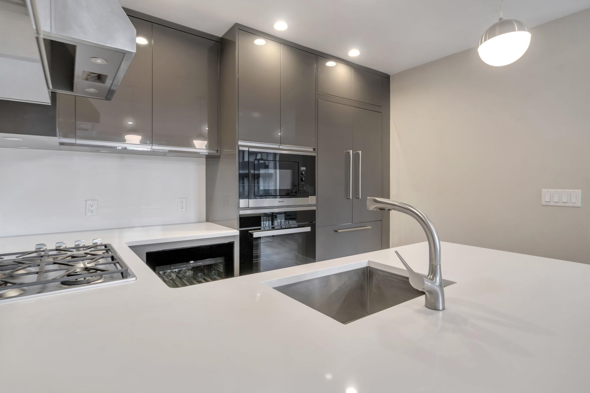 61 14th Street, Unit 3 Hoboken, NJ 07030 - Photo 14 of 31 a kitchen with kitchen island a sink stainless steel appliances and cabinets