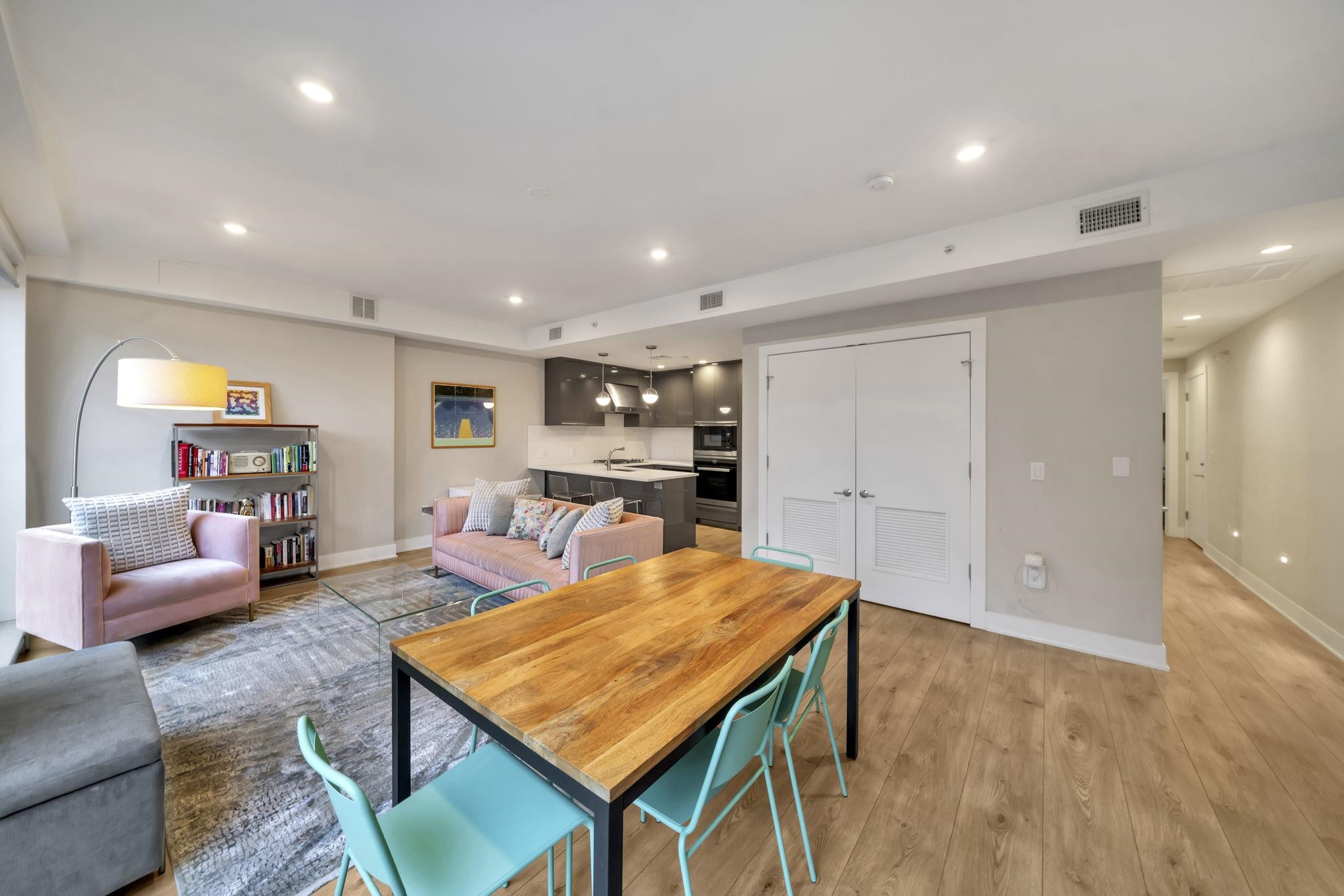 61 14th Street, Unit 3 Hoboken, NJ 07030 - Photo 15 of 31 a living room with furniture a table and kitchen view