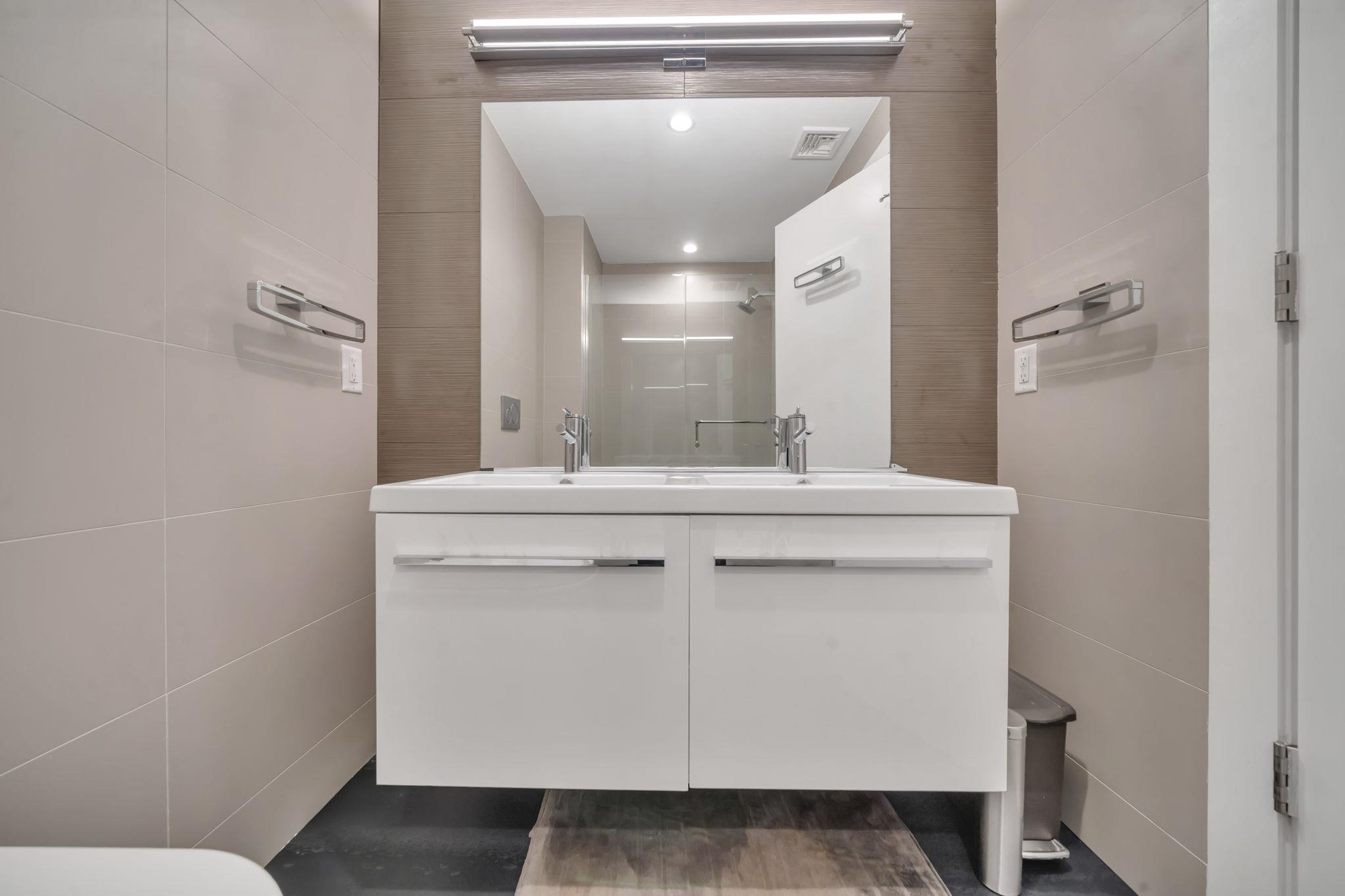 61 14th Street, Unit 3 Hoboken, NJ 07030 - Photo 19 of 31 a bathroom with a sink and a mirror