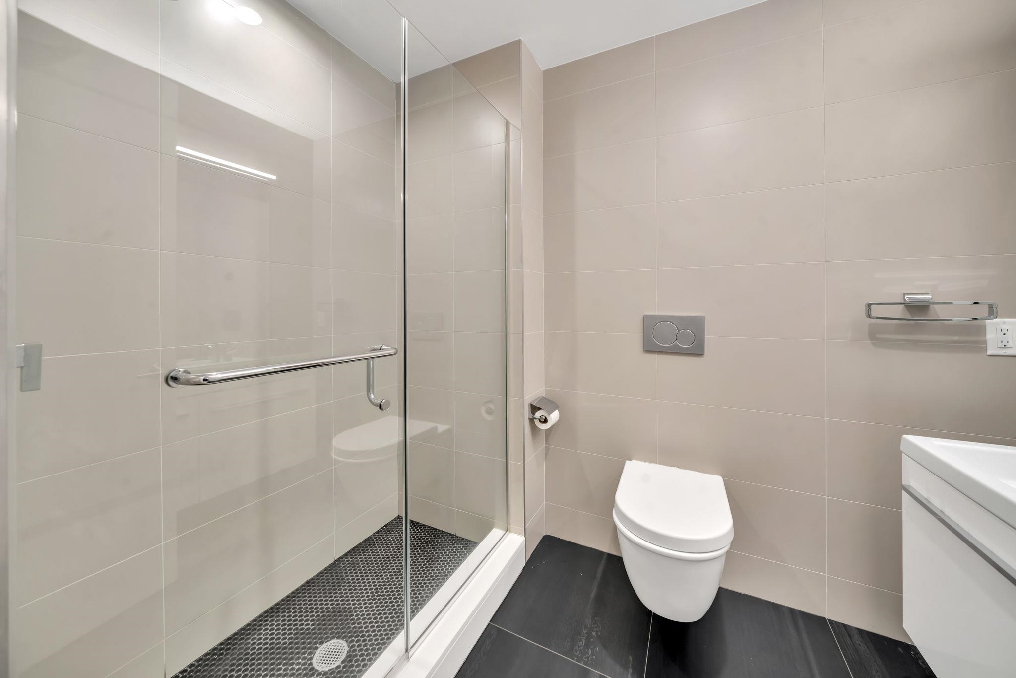 61 14th Street, Unit 3 Hoboken, NJ 07030 - Photo 20 of 31 a bathroom with a toilet and a shower