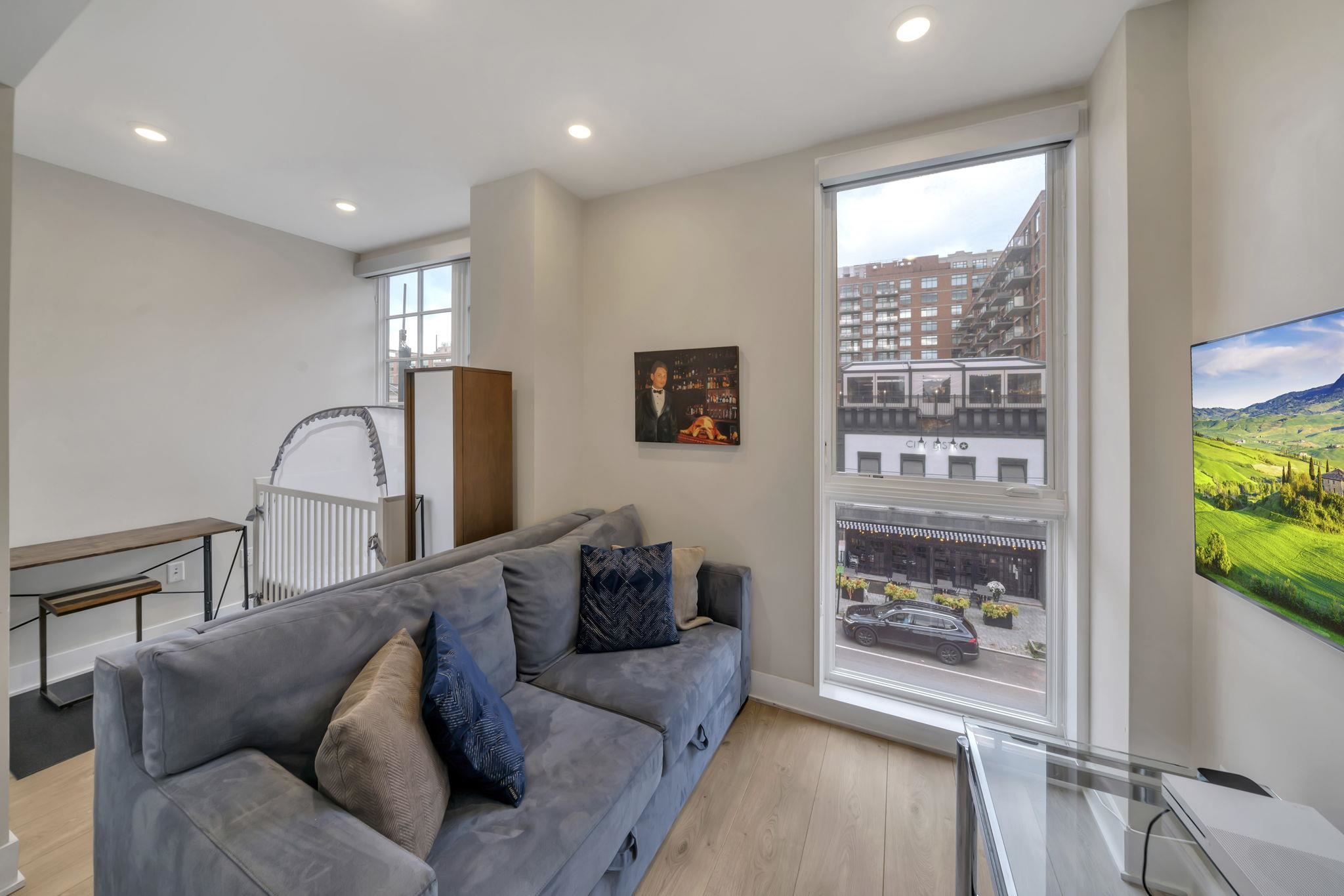 61 14th Street, Unit 3 Hoboken, NJ 07030 - Photo 21 of 31 a living room with furniture and a window