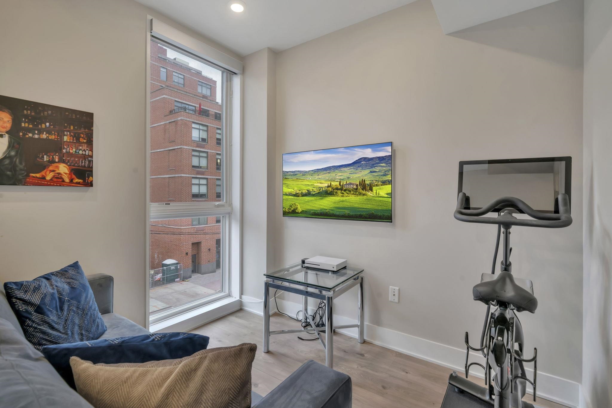 61 14th Street, Unit 3 Hoboken, NJ 07030 - Photo 22 of 31 a living room with furniture and a flat screen tv