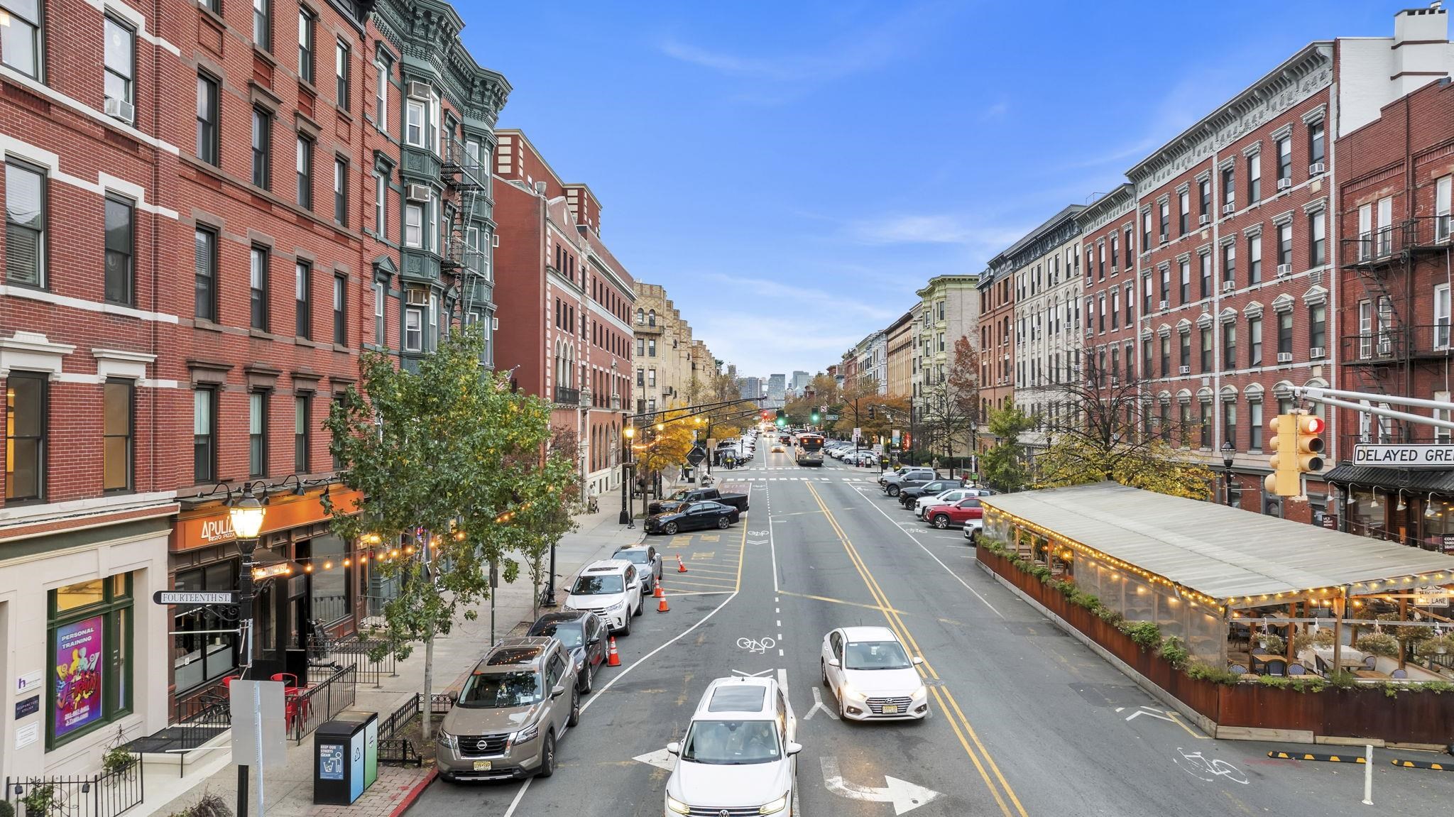 61 14th Street, Unit 3 Hoboken, NJ 07030 - Photo 28 of 31 a city street lined with tall buildings