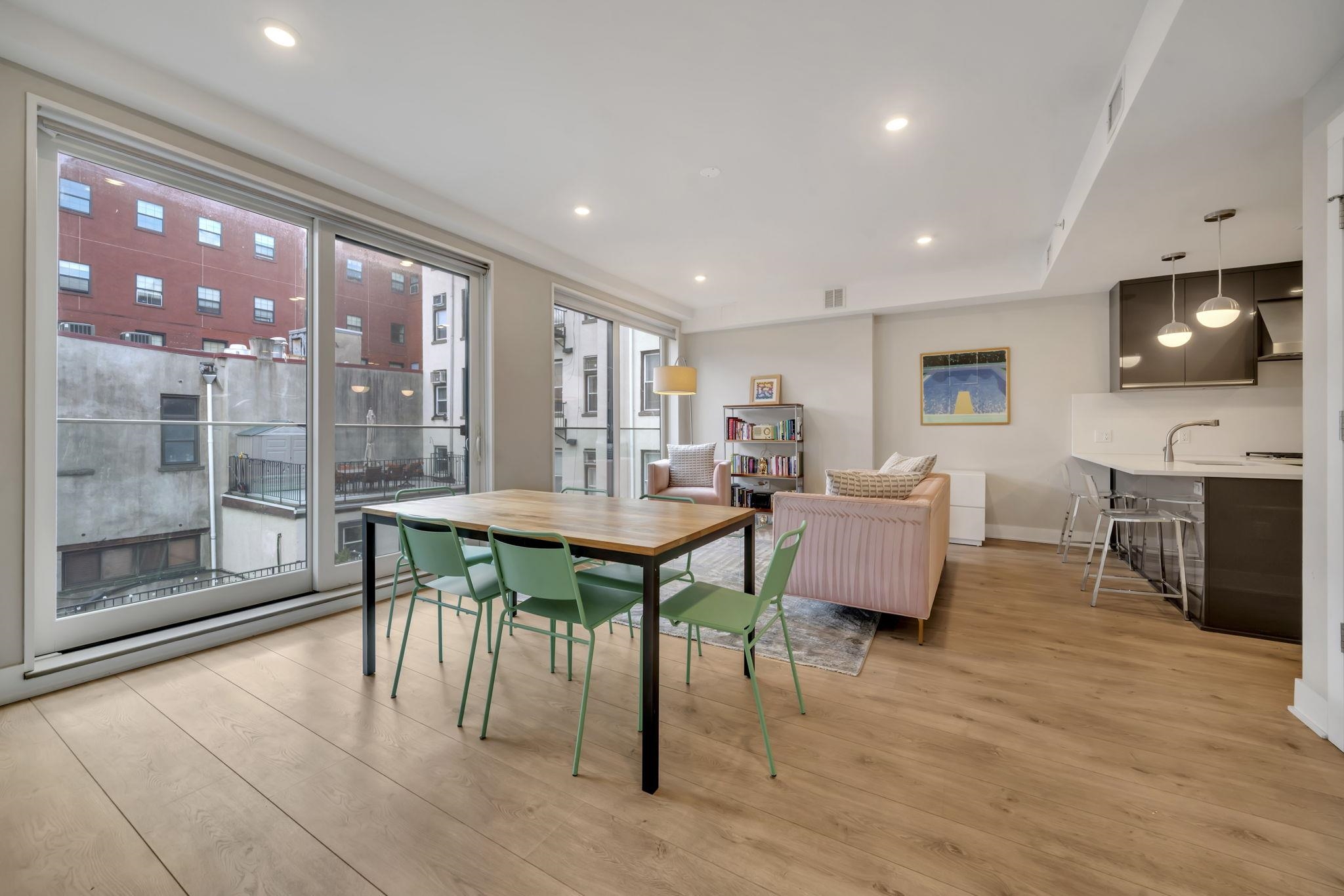 61 14th Street, Unit 3 Hoboken, NJ 07030 - Photo 3 of 31 a view of a dining room with furniture window and wooden floor
