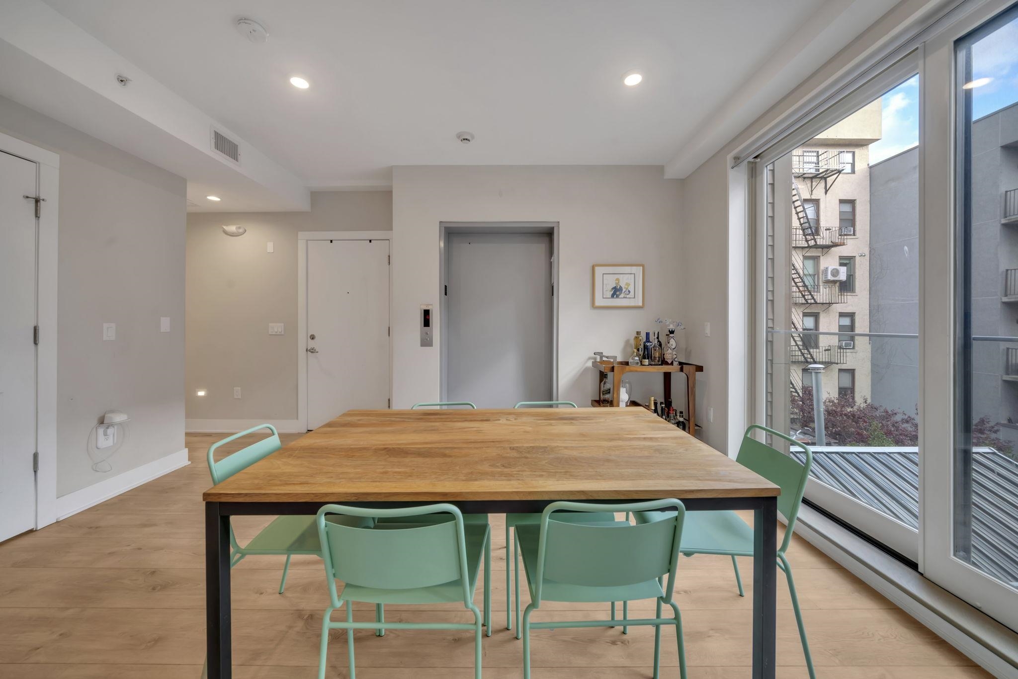 61 14th Street, Unit 3 Hoboken, NJ 07030 - Photo 10 of 31 a view of a dining room with furniture and wooden floor