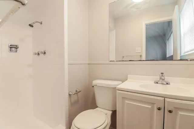 a bathroom with a sink mirror and toilet