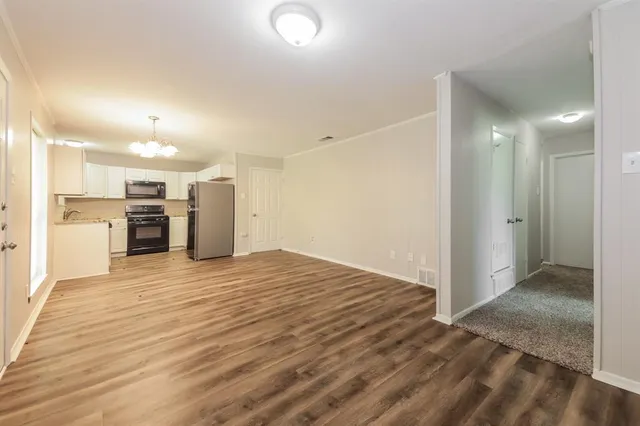 a view of a kitchen with a sink and a refrigerator