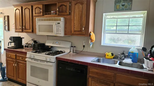 a kitchen with cabinets appliances and a window