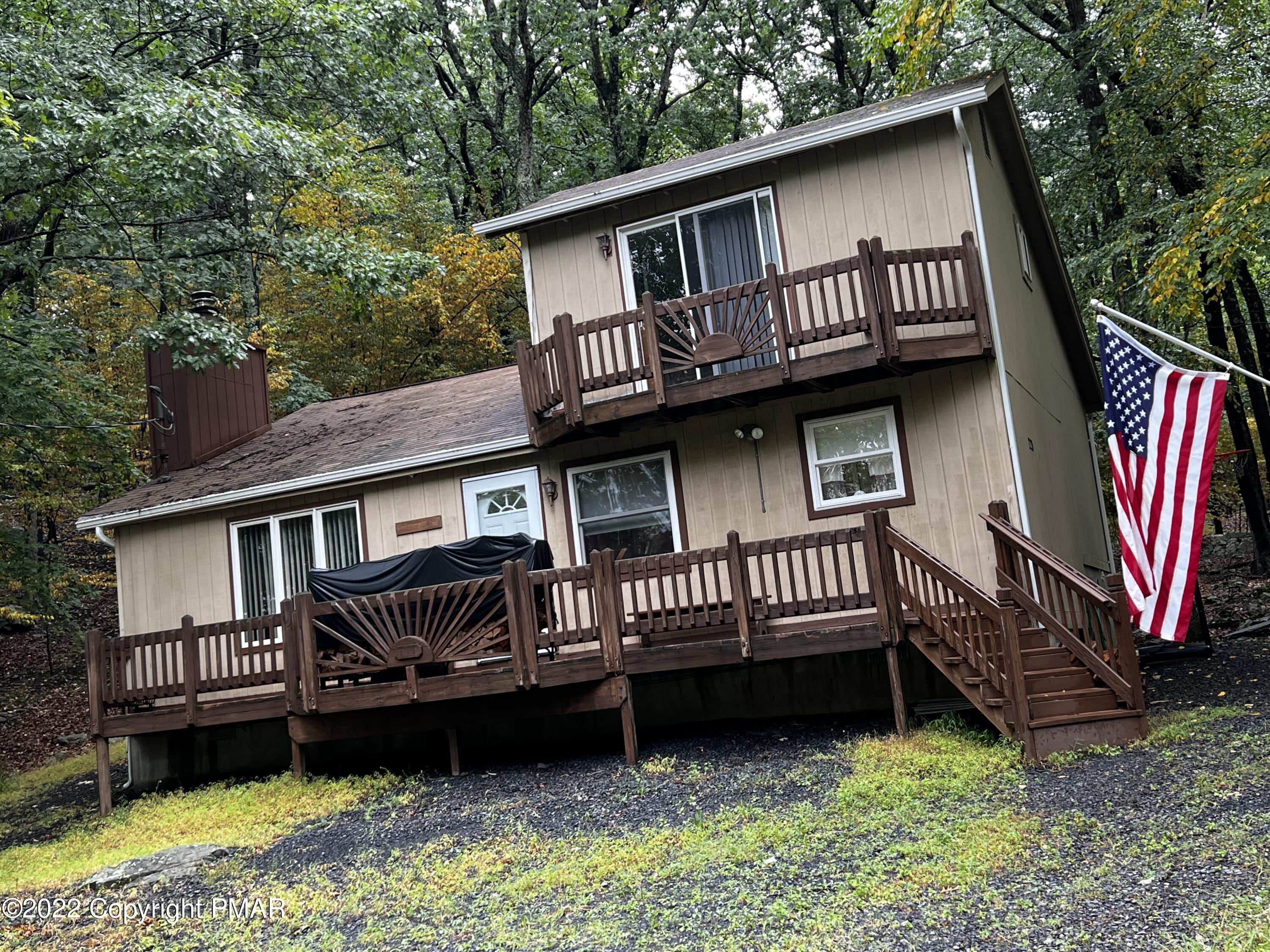153 Edinburgh Road Bushkill, PA 18324 - Photo 1 of 24 a view of a house with a wooden deck and a yard